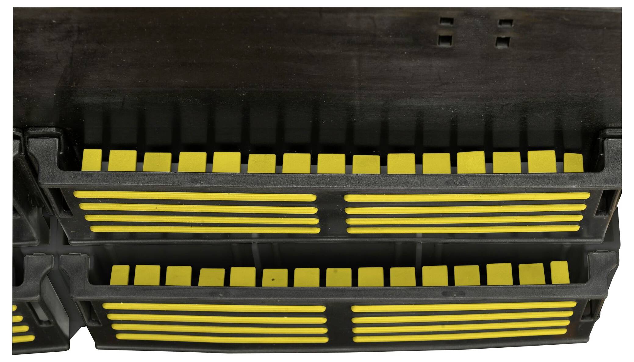 Yellow stripes on a black grid, likely an inductive charging coil or antenna that is part of an electronic device.