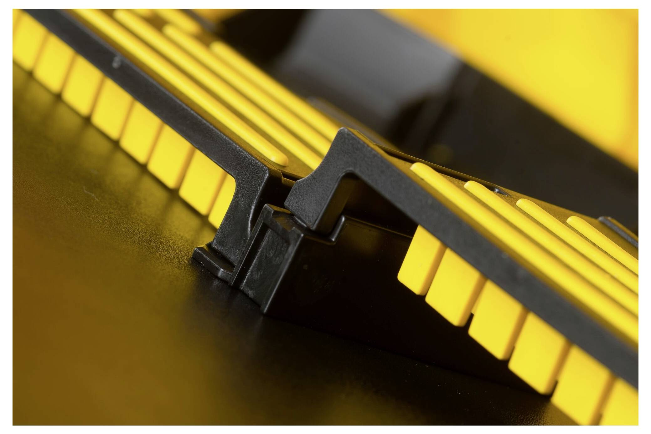 Close-up of yellow and black RAM modules in a computer, focused on the connection between the sticks.