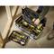 An open toolbox on a wooden floor, filled with various tools, including a drill and a spirit level. Two hands using or arranging the tools.