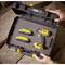 A tool case with a hand drill and two rechargeable batteries. A hand is opening the case.