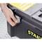 A hand is opening the latch of a black toolbox with a yellow handle on a dotted background.