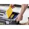 A hand opens a yellow cover of a toolbox and reaches for wall plugs in various colours.