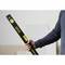 A person is holding a Stanley FatMax spirit level, which is used for precise measurements.