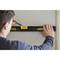 A man is levelling a wall with a spirit level.