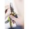 A person is holding a combination pliers and manipulating a small object. The focus is on the pliers with yellow accents.