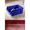 A blue plastic box containing yellow tools sits on a worn wooden floor in front of a red stair step.