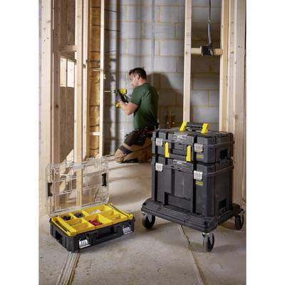 A tradesman working in an unfinished room, with a portable toolbox and open organiser in the foreground.