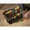 An open toolbox on a wooden surface, filled with various hand tools such as screwdrivers and pliers.
