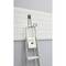 A ladder is leaning against a grey wall, on which white, horizontal shelving brackets are mounted. At the top, a black hammer is hanging.
