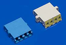 Two plastic plugs on a blue background; on the left a blue one with three connections, on the right a white one, slightly angled.