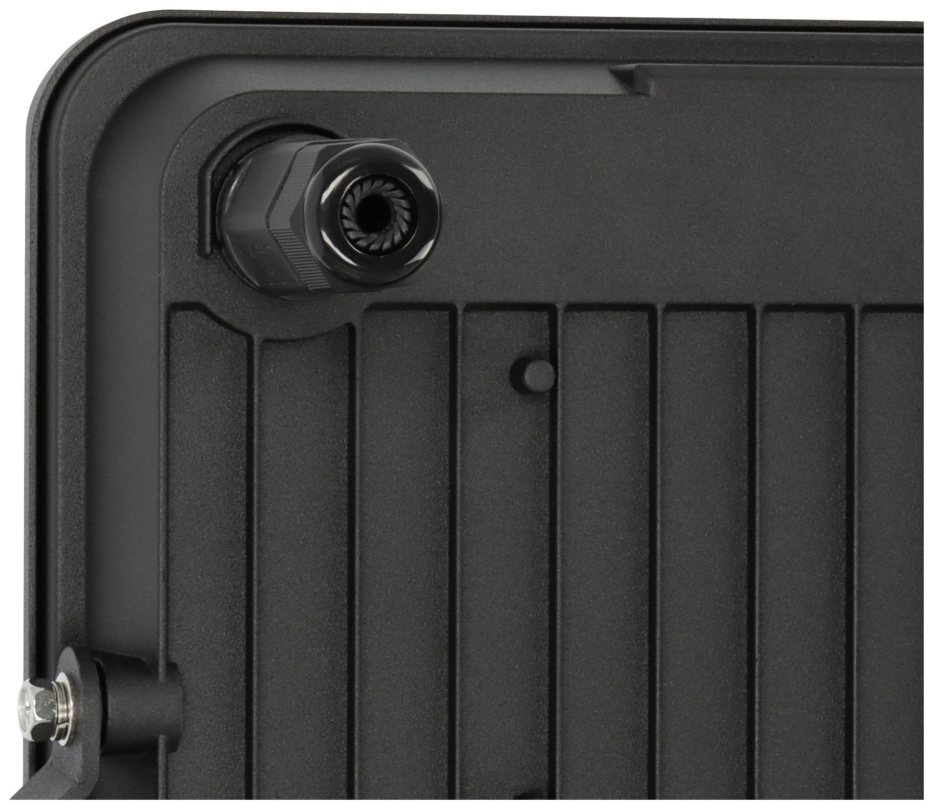 Back of a black device with a ribbed surface and cable connection in the corner.