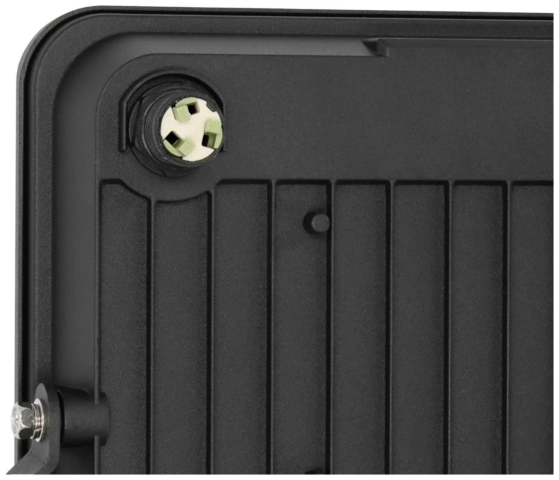 Detailed view of a black, ribbed surface with a metallic screw at the edge and a star-shaped opening.