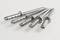 Five silver metal dowels are arranged in a fan-like pattern on a white background.