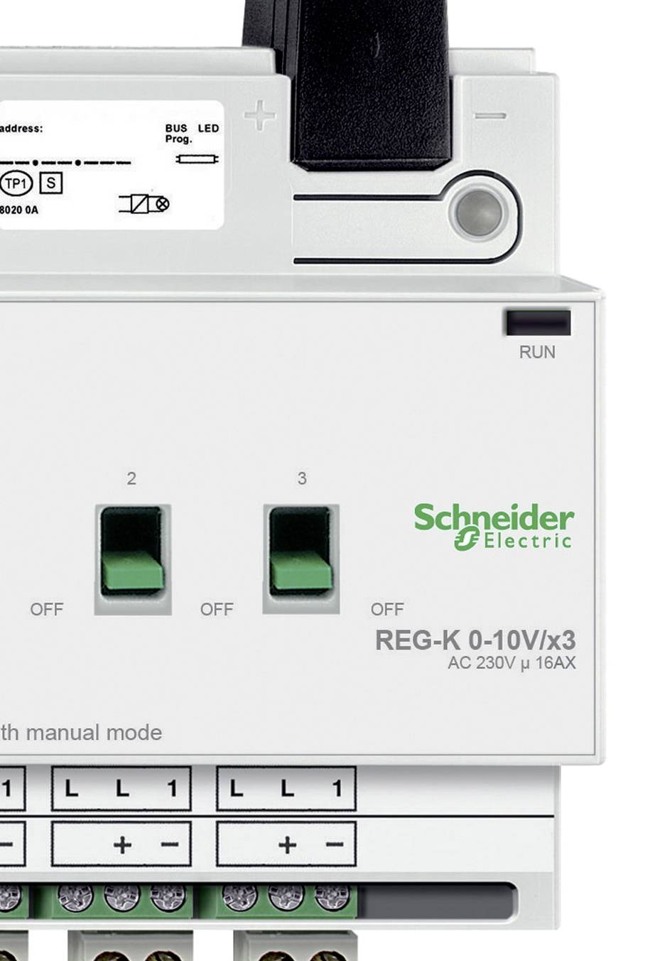Electrical switchboard device by 'Schneider Electric' with two green switches and label 'REG-K 0-10V/x3 AC 230V μ 16AX'.