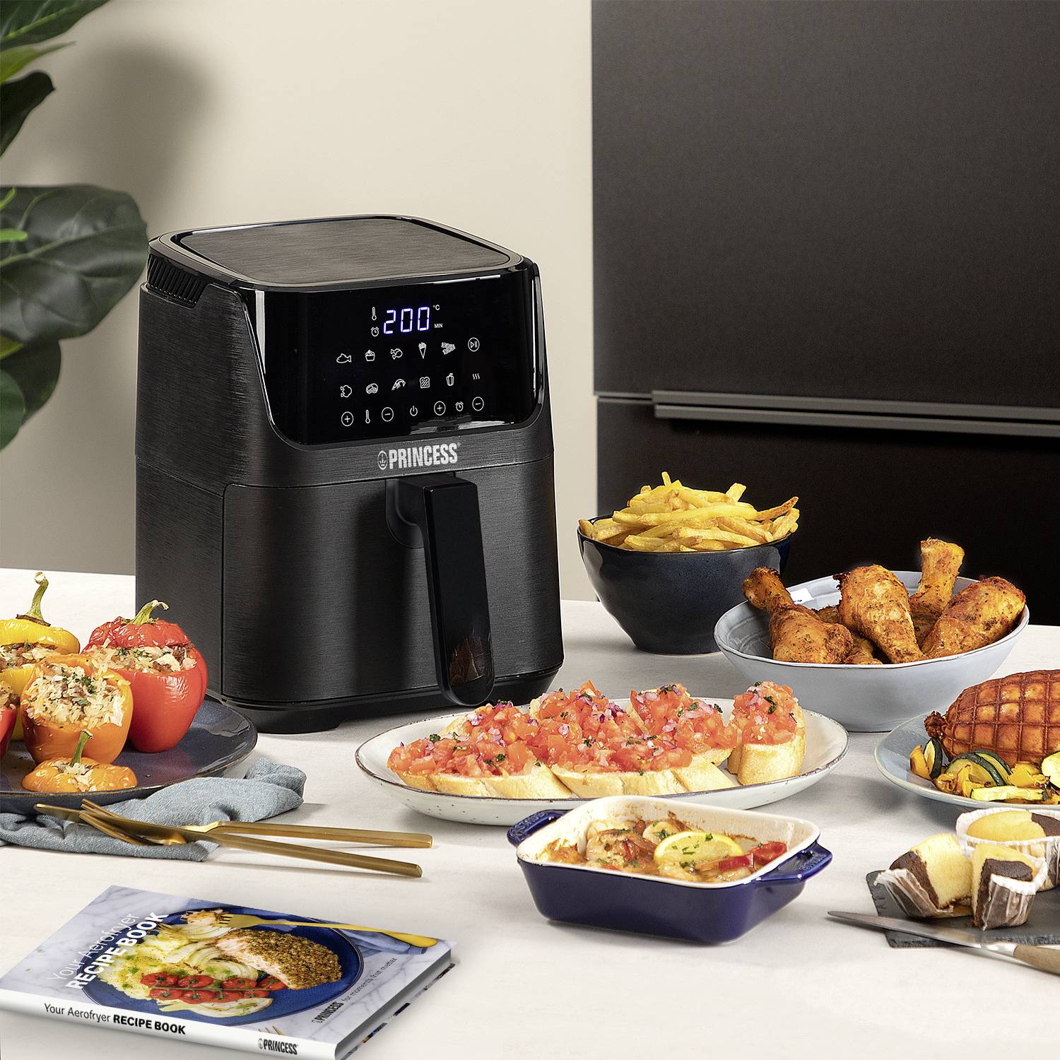 A hot air fryer sits on a table, surrounded by plates of various dishes such as chips, vegetables, and meat dishes.