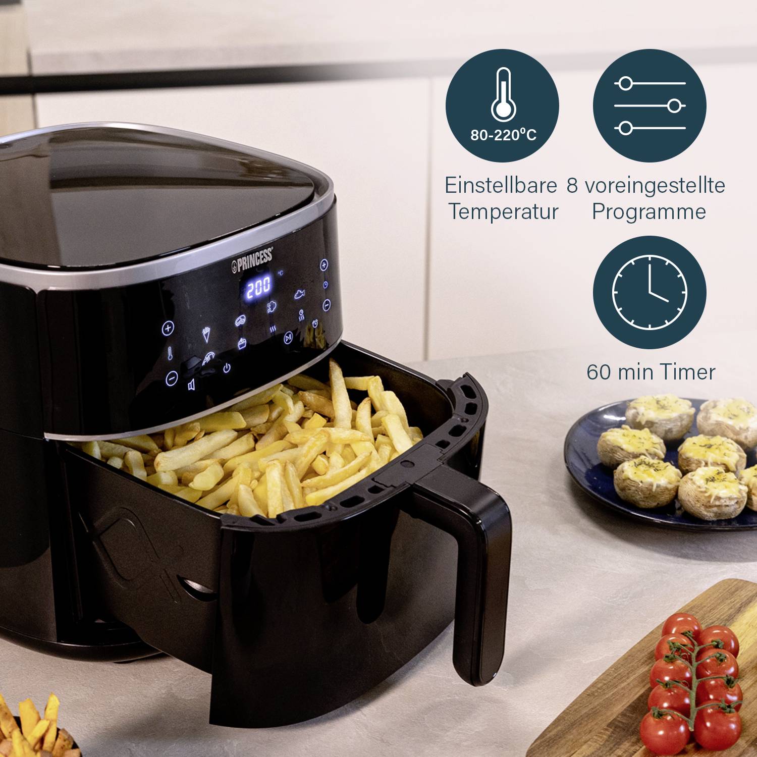 A black air fryer with a drawer full of chips. On the right side are symbols indicating temperature, programmes, and timer.