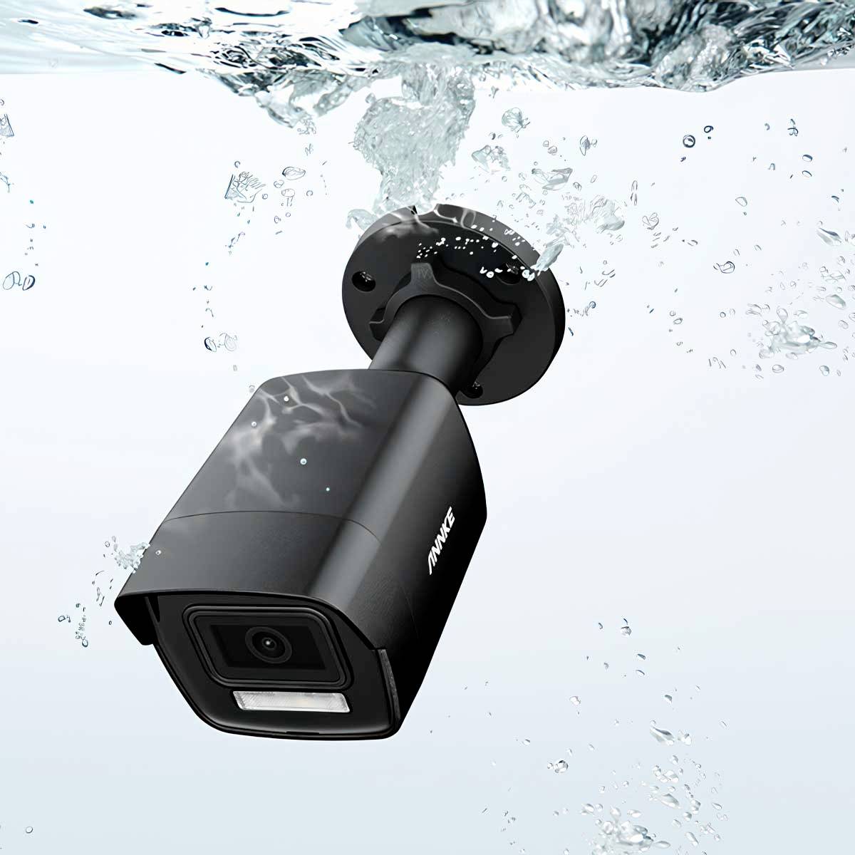Surveillance camera submerged in water, demonstrating waterproof design, suitable for outdoor use in various weather conditions.