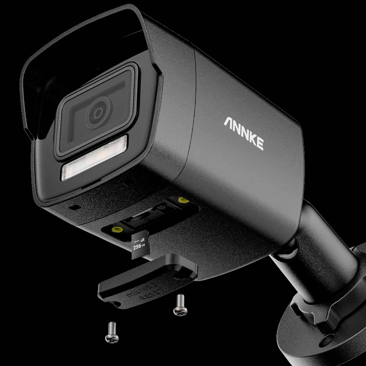 Black surveillance camera by 'ANNKE', mounted on a stand, showing front lens and memory card slot.