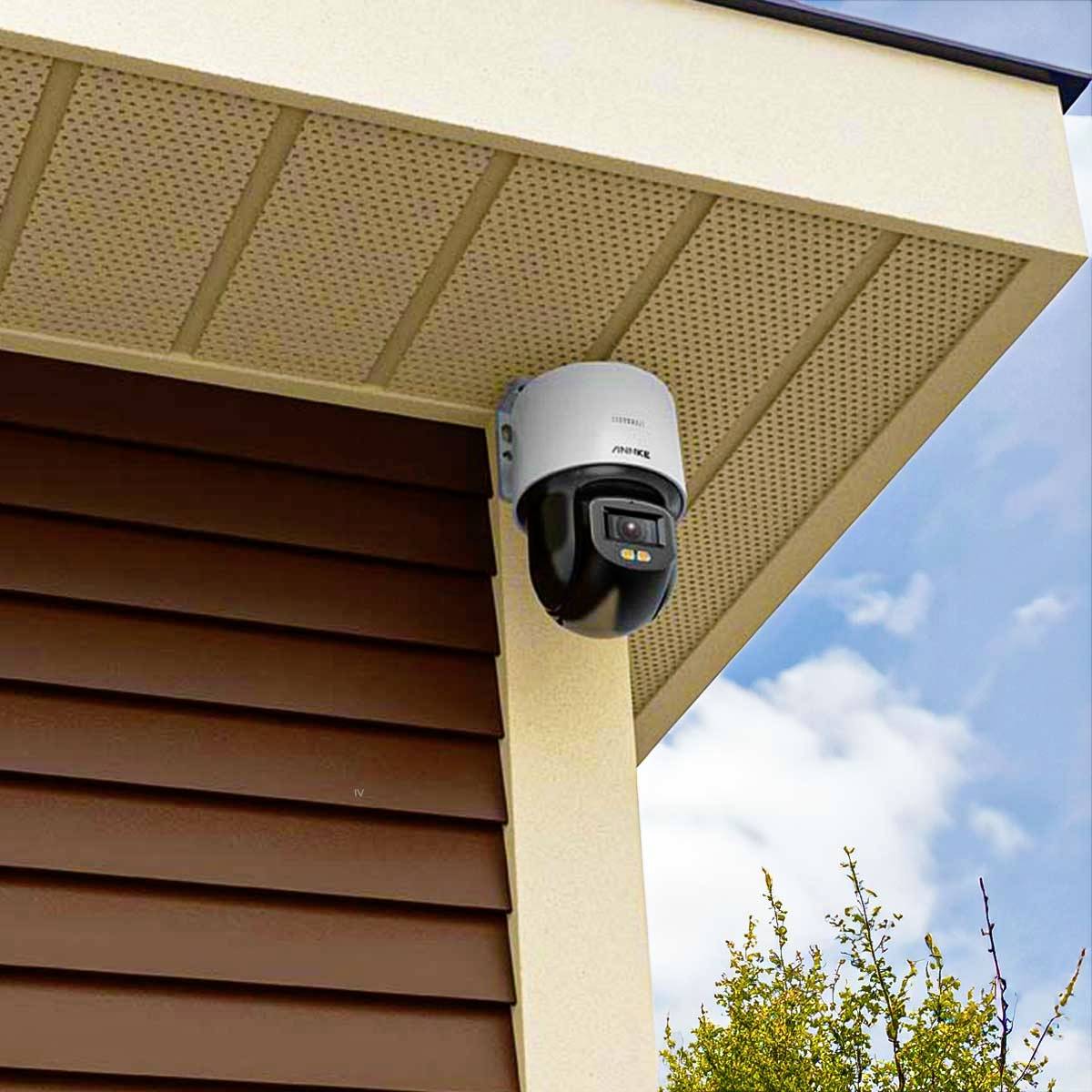 Security camera at the building's corner, view of blue sky and tree.<br><br>Note: While this looks like an English translation already, here's a more British-styled version:<br><br>CCTV camera at the building's corner, view of blue sky and tree.