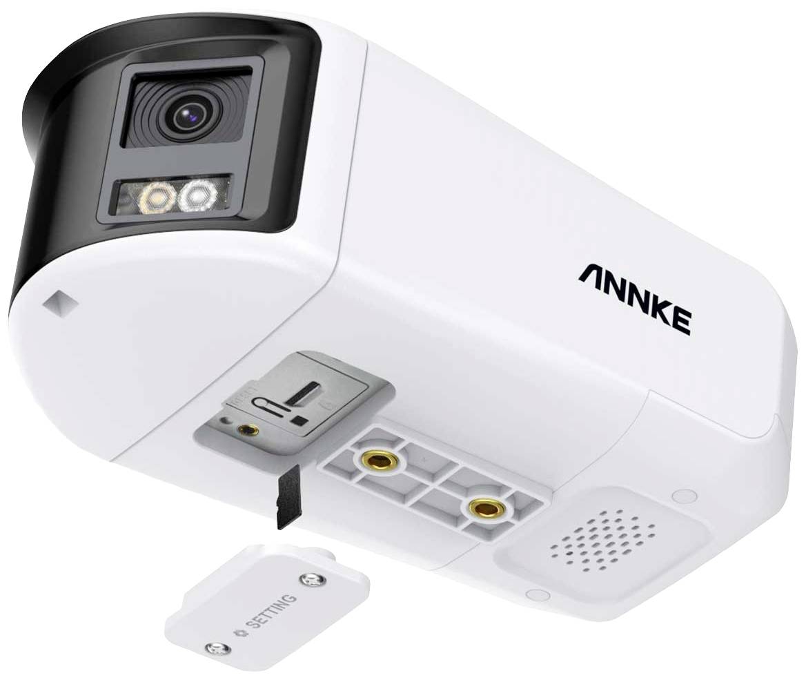 Surveillance camera with motion sensor and night vision function. Camera shows the open battery compartment and a detached cover.