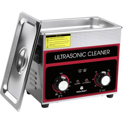 An ultrasonic cleaner with a metal casing, labelled 'Ultrasonic Cleaner'. Two rotary knobs for time and heating temperature are visible.