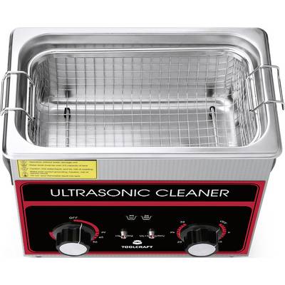 Stainless steel ultrasonic cleaner with mesh insert, two adjustment knobs and warning notices on the front.