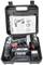 Cordless drill set in a case with two batteries, a charger and an instruction manual. The main tool is a black drill.