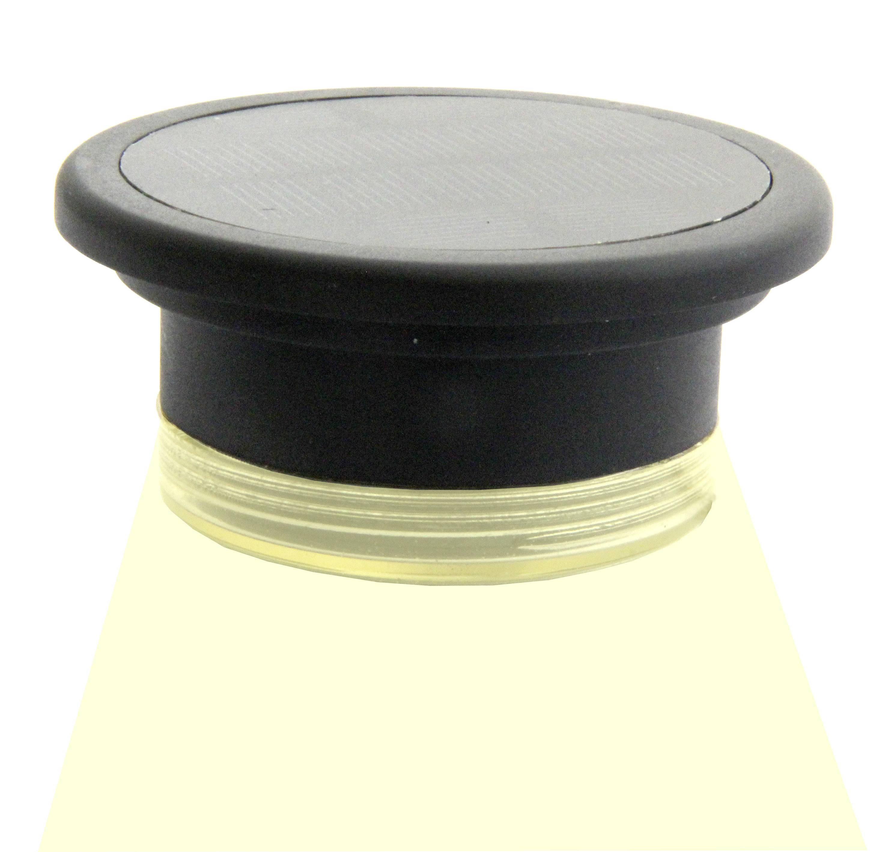 A black round light source that radiates yellow light downwards, used in furniture or ceilings.