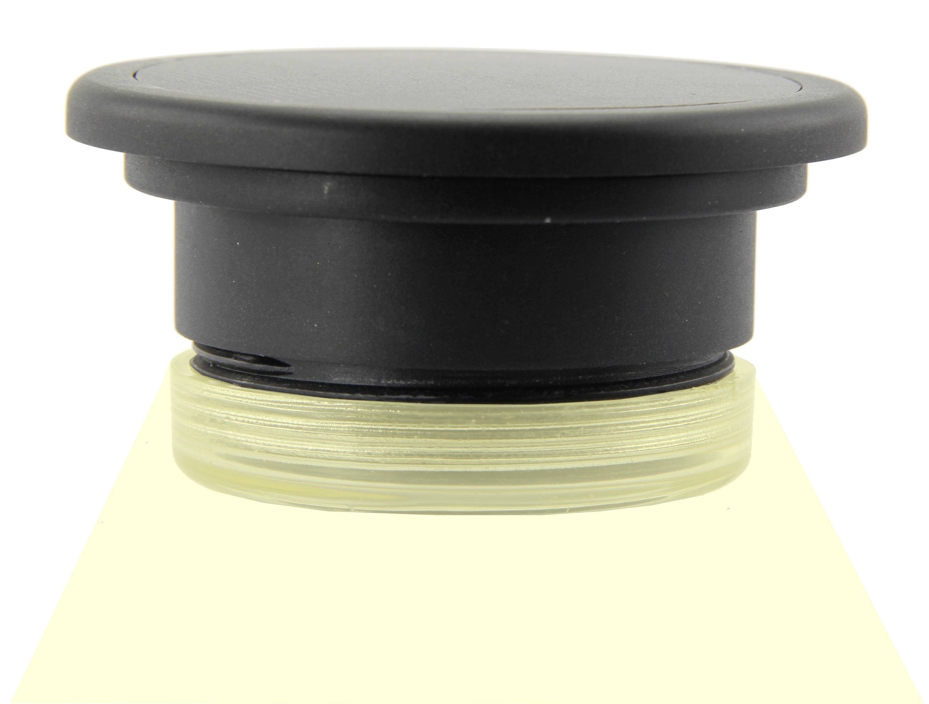 A black round lid is firmly seated on a glass container with a transparent thread.
