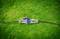 An irrigation valve is lying on green grass.