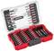 An open set of multiple screwdriver bits and inserts, neatly sorted and arranged in a red plastic case.