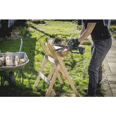A person is sawing wood on a pair of trestles, with a wheelbarrow full of logs nearby.