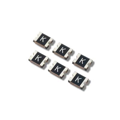 Six small SMD fuses with the letter 'K' on a black background, arranged in two rows of three.