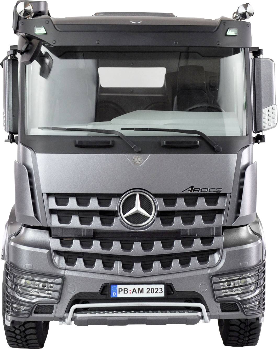 Silver lorry from the front, distinctive radiator grille with Mercedes logo, model name 'Arocs' visible on the right side.