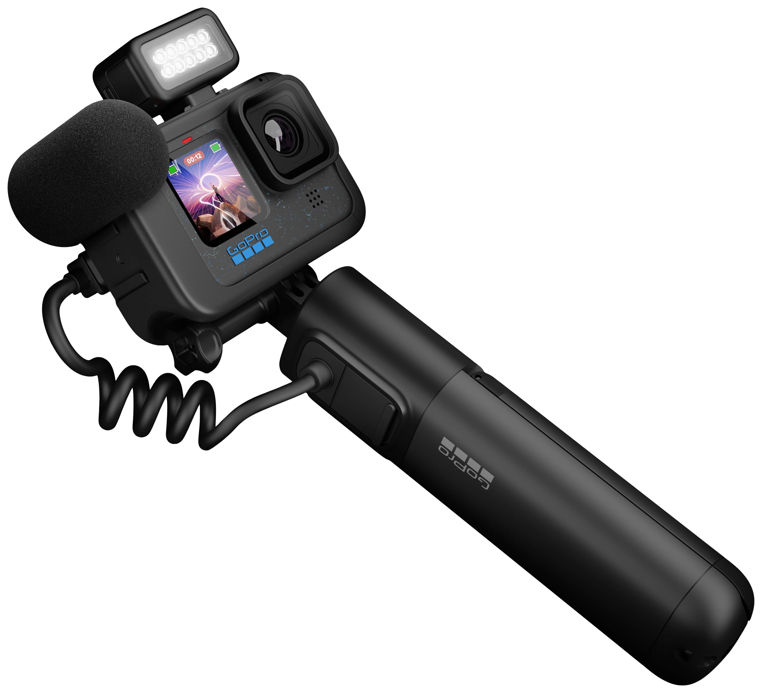 A black action camera with a microphone and display showing an image. It is mounted on a sturdy grip with an integrated battery.