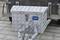 Metal toolbox with diamond pattern and lock, mounted on a trailer, identifiable by the 'Alutec' logo on the front side.
