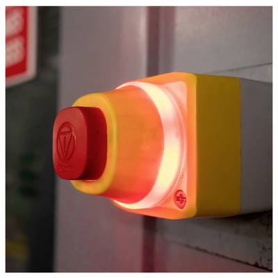 Glowing red emergency stop button mounted on a wall panel<br>