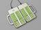 Batteries in a twin charger, several green rechargeable batteries being charged simultaneously. Each slot indicates a red or green charging status.