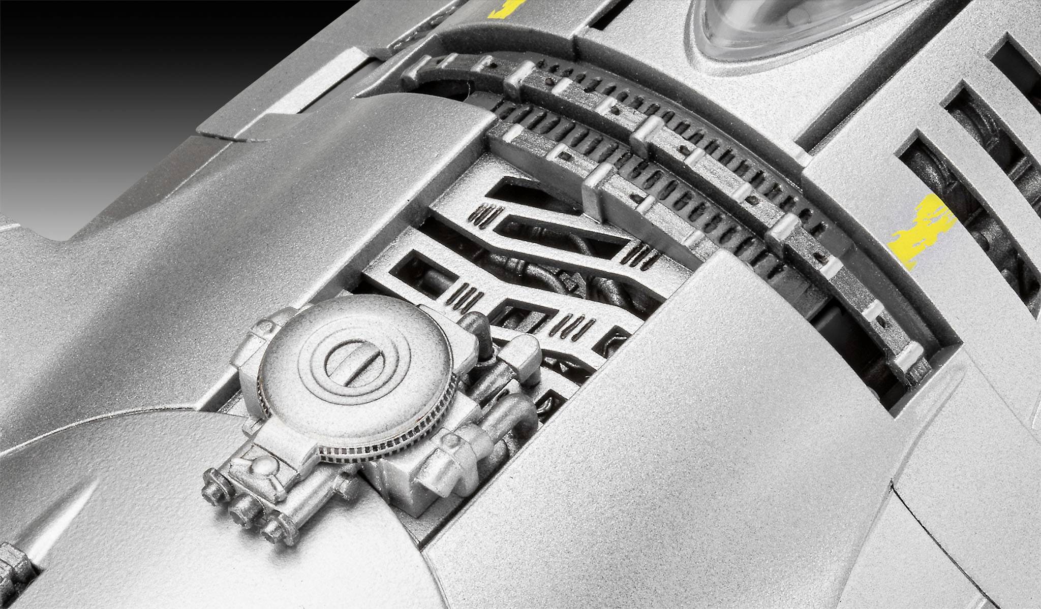 Close-up of a silver mechanical watch movement with gears and textured metal plates.