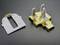 White and gold model parts on a black background, possibly for an architectural or technical model.