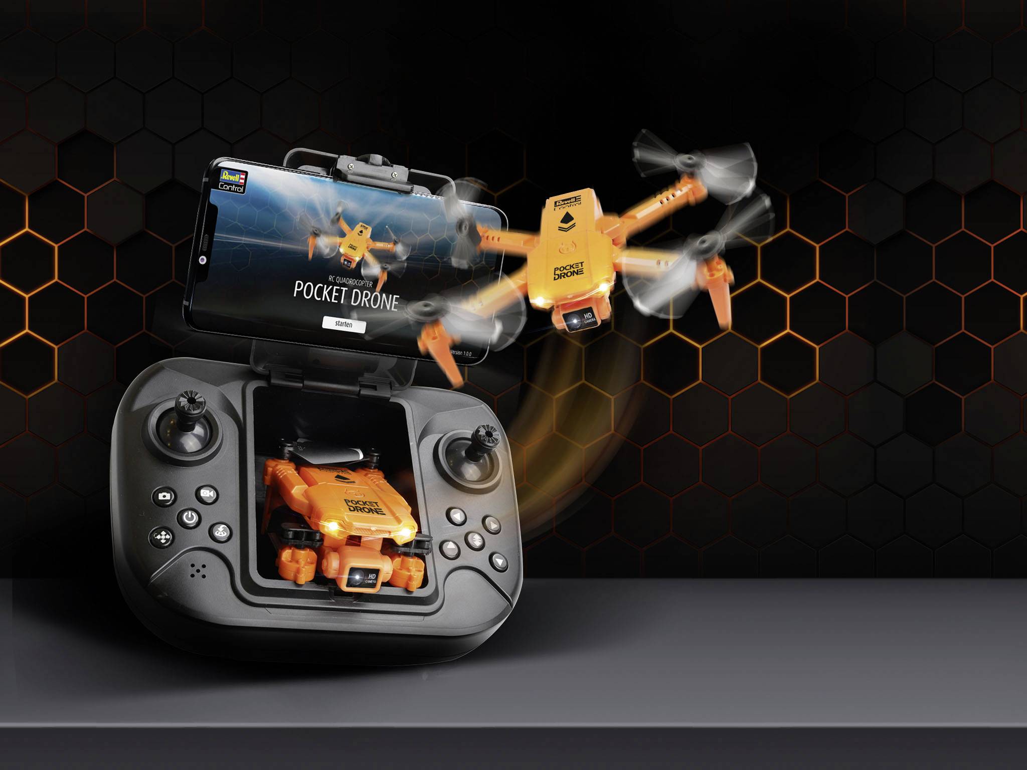 A small orange drone flies above a remote control with an integrated screen, which displays the drone. The drone has movable rotors.