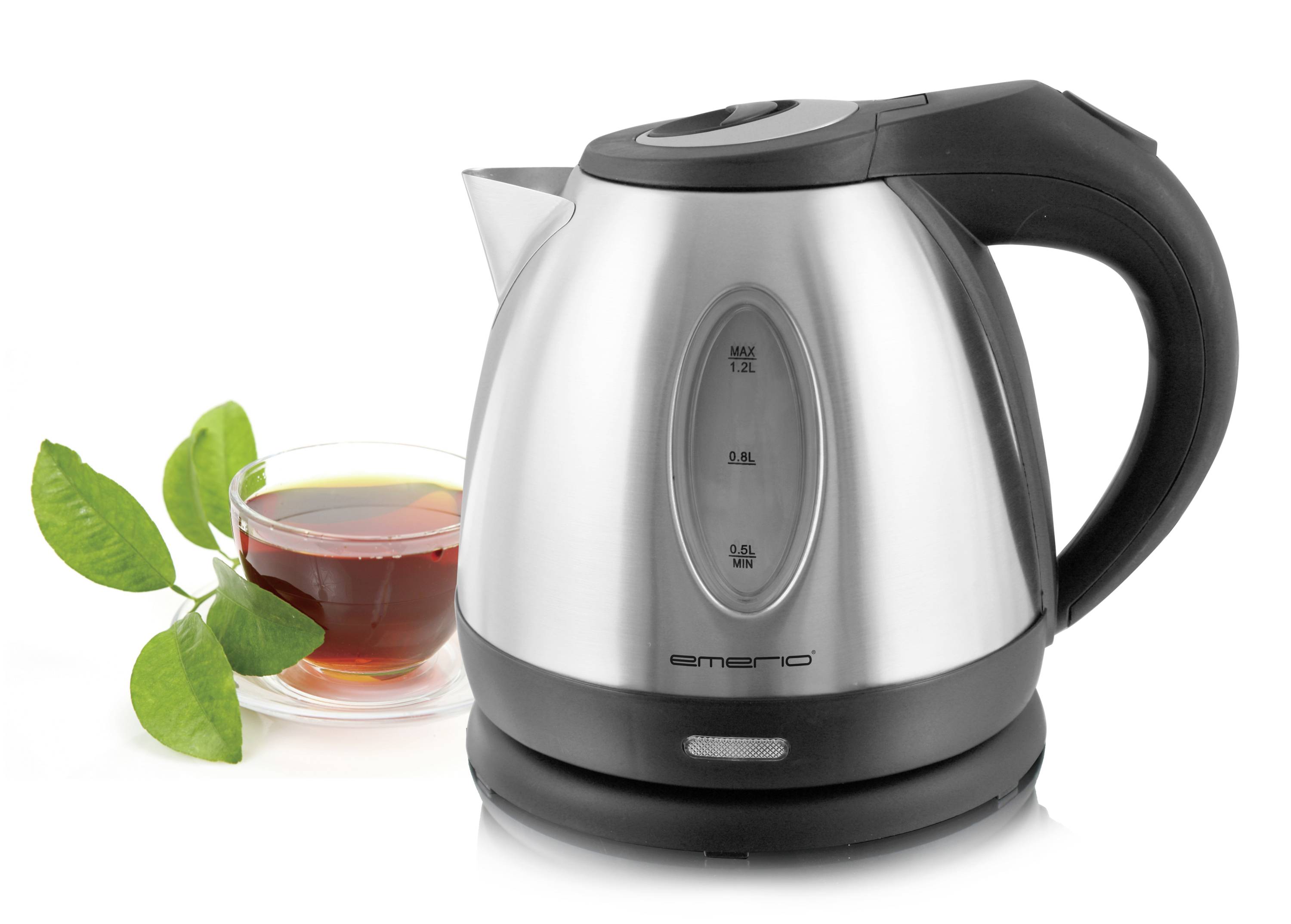 A silver electric kettle next to a cup of tea with fresh tea leaves.