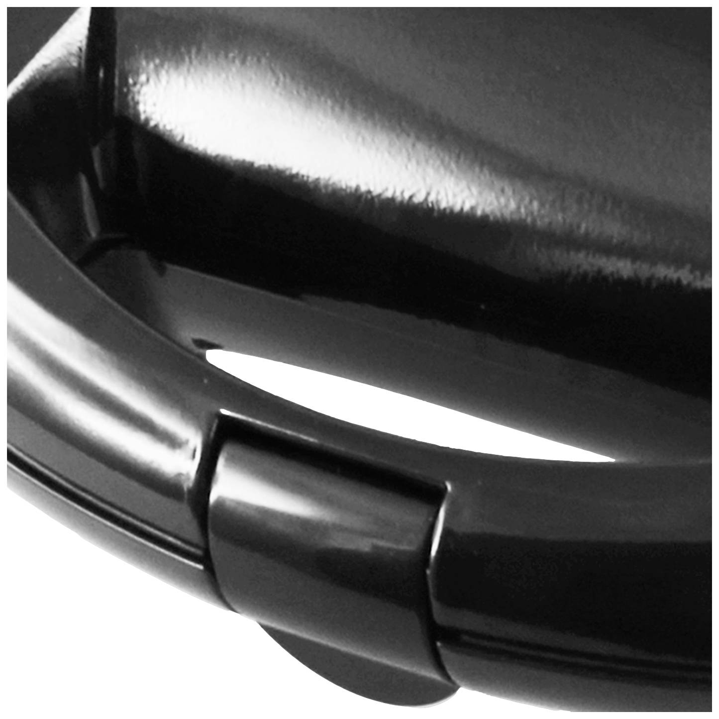 Close-up of a glossy, black handle with a round opening beneath it.