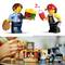 Two Lego figures are facing each other. One is holding a burger, the other a ketchup bottle. Beneath them, a child is playing with the figures and a fast food set.