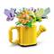Colourful LEGO watering can, from which a vibrant flower with multicoloured petals and two butterflies sprouts.