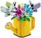 Colourful brick floral arrangement in a yellow watering can. Contains brick-built butterflies. Decorative element.