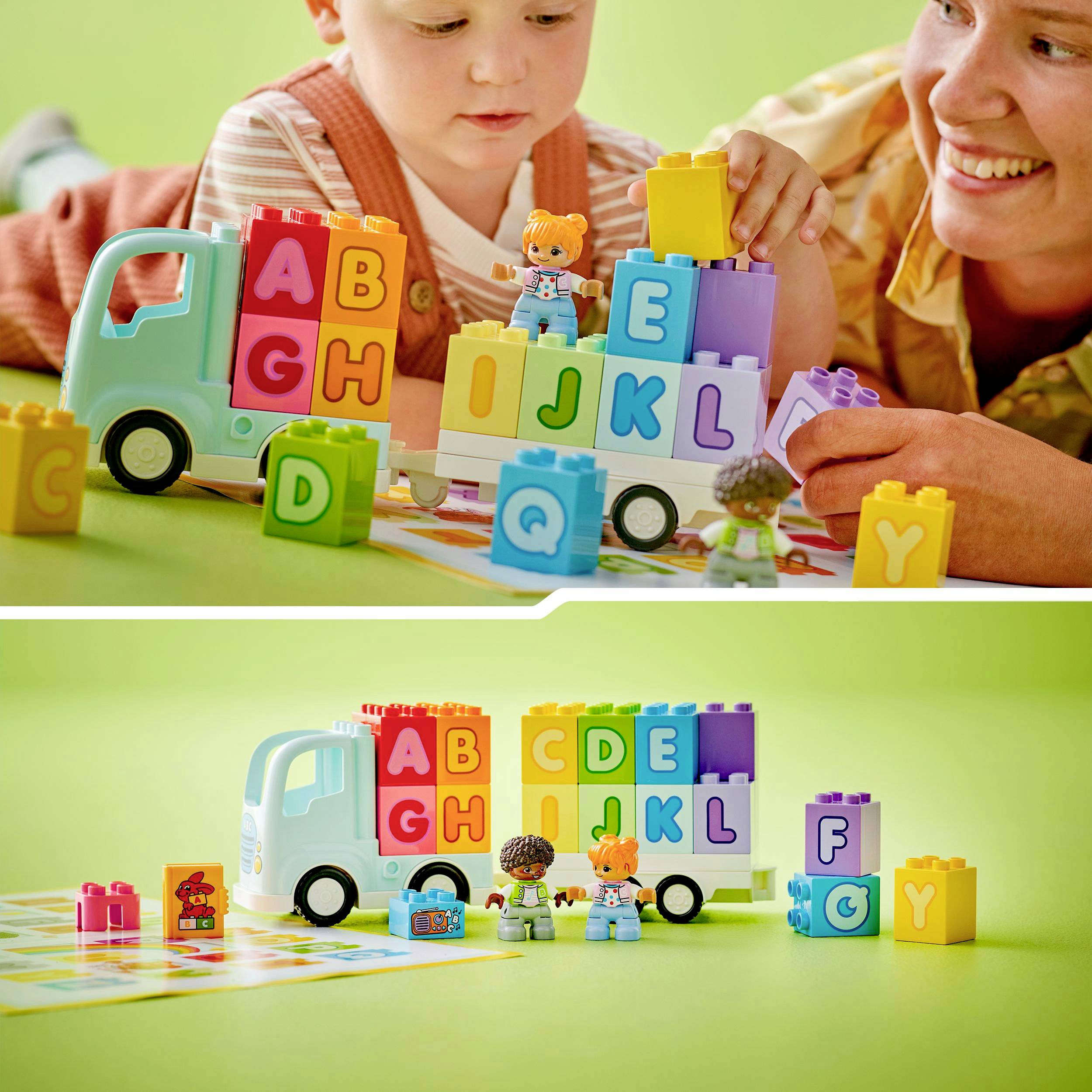 A toddler and an adult are playing with colourful building blocks and a toy lorry. Letters are written on the blocks.