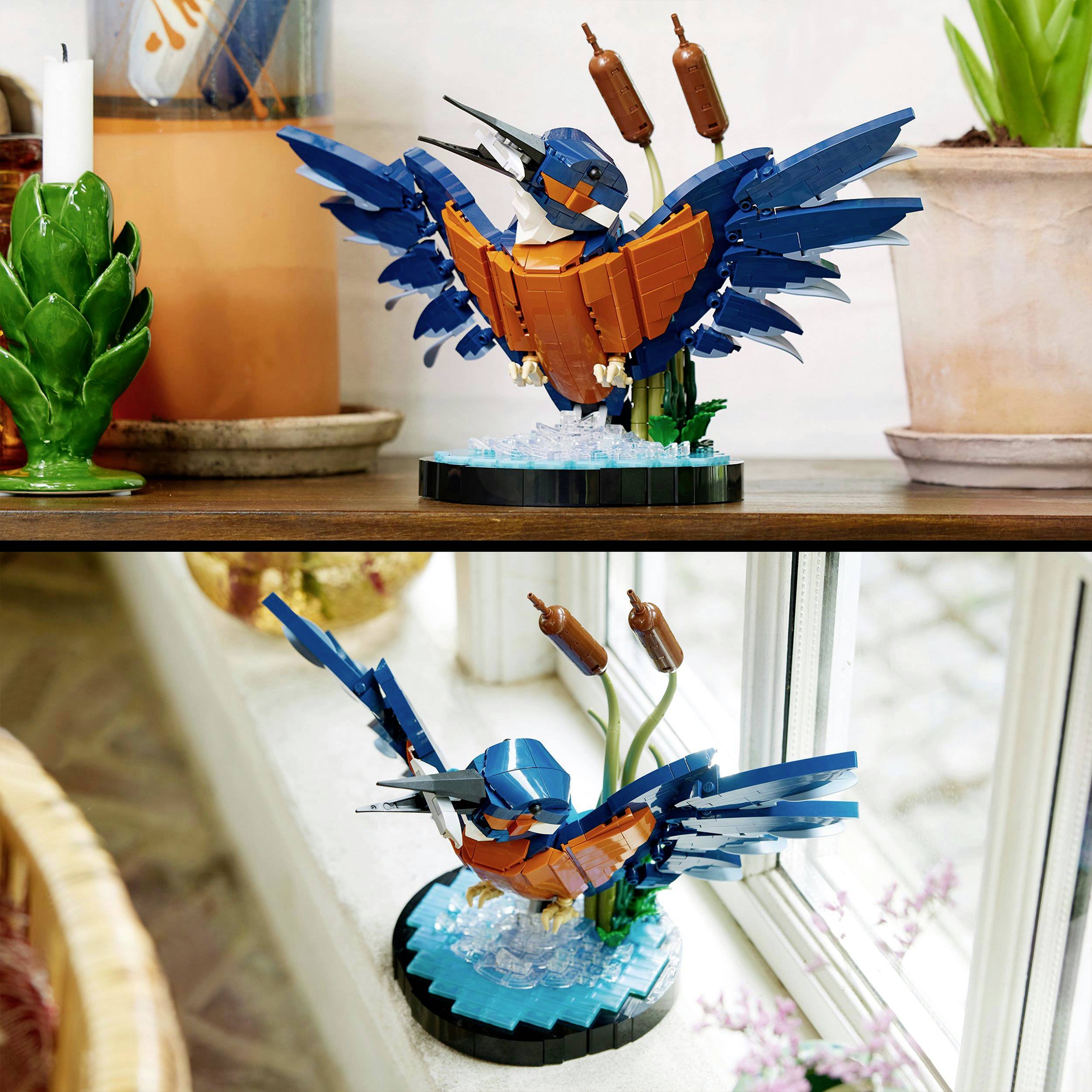 A colourful block bird in a flying pose, stands on a wooden surface beside plants. It mimics a flying kingfisher.