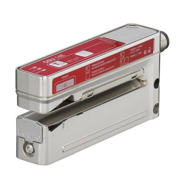 Metal sensor device with a red control panel and multiple indicator displays, suitable for industrial use in object or material detection.