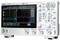 Electronic oscilloscope with large display showing wave-form signals. Controls and connections visible for measurements.